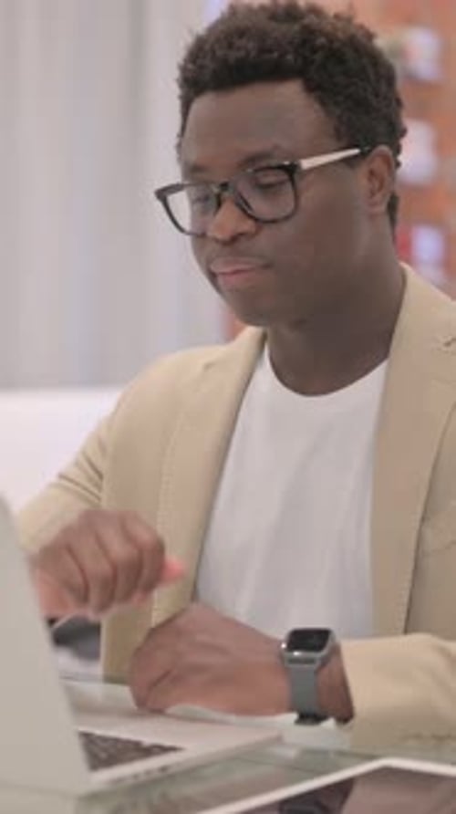 Young Adult Man Video Conferencing at Workplace