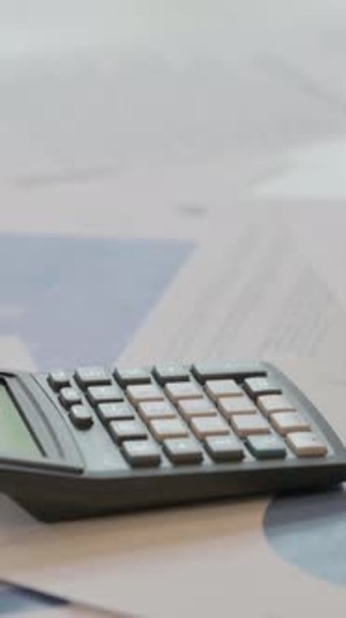 Close up of Middle Aged Businessman Writing on Paper, using Calculator, Vertical Video