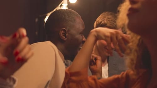 Adults Dancing and Clapping at Indoor Party