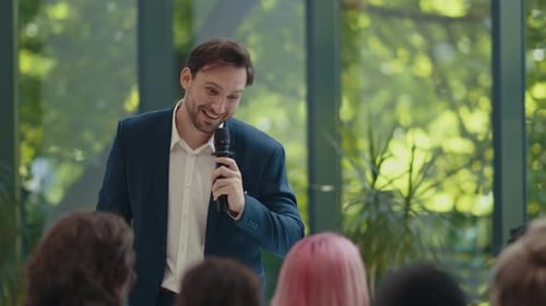 Man Giving Speech to Audience Indoors
