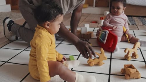 Babies Playing With Wooden Toys Indoors
