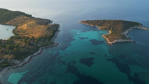 Aerial Video of a Scenic Coastline with Turquoise Water Sandy Beaches and Boats Anchored in Hidden