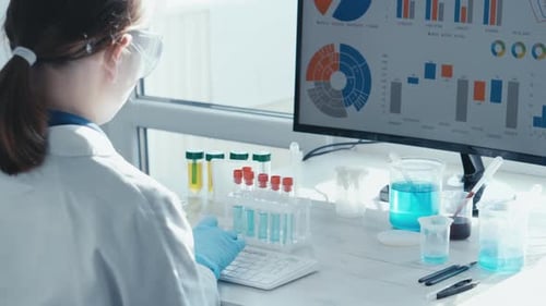 Scientist Typing Data in Bright Modern Laboratory