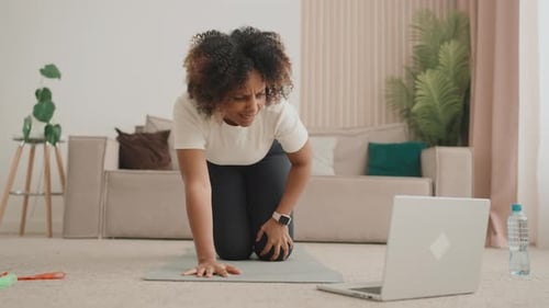 Woman Experiencing Knee Pain During Workout at Home