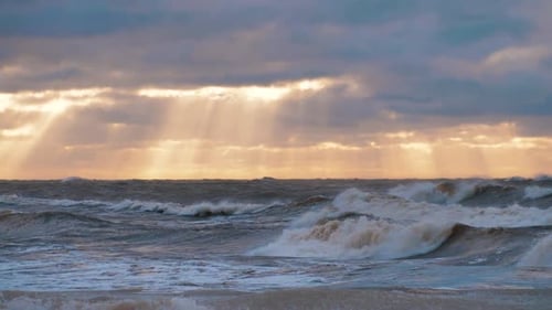 Sea storm with big waves at sunset. Strong waves on the sea coast. Selective focus
