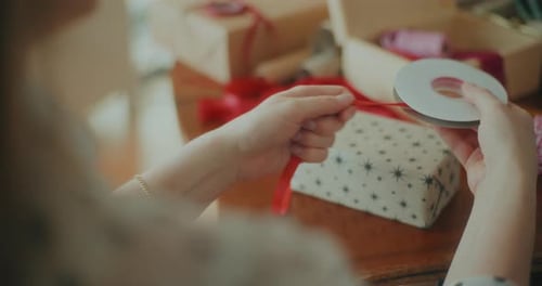 Joyful Woman Decorating Wrapping Christmas Gifts For Xmas Holidays