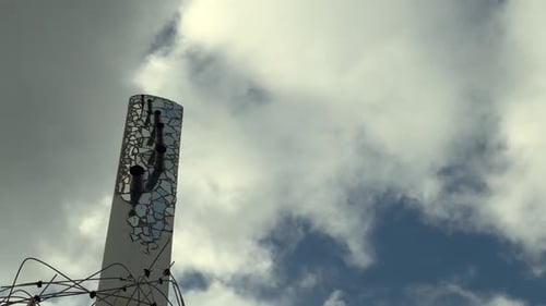 Abstract Art Installation Under Cloudy Sky