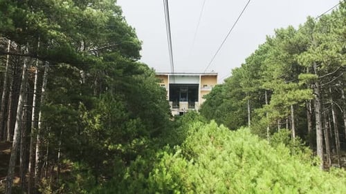 View from the cabin on the cable car on a sunny summer day in the mountains. View of the station. Sp