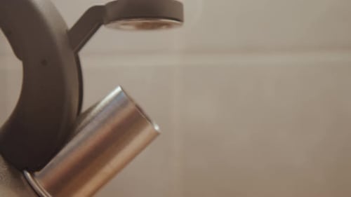 Closeup Metal Spout Resting on Counter Muted Tile Background Brushed Stainless Texture Quiet Pause