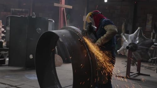 Worker polishing a ring in metal industry medium plane