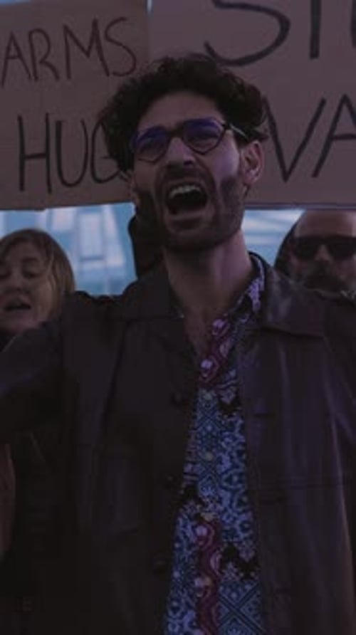 People Protesting on a City Street with Signs