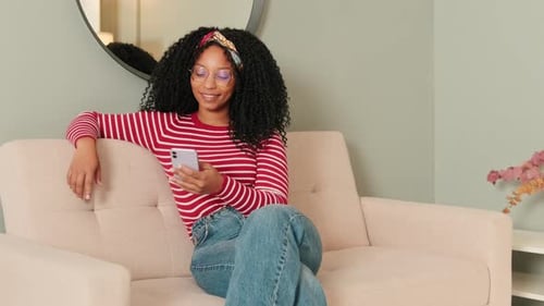 Woman Relaxing on Couch with Mobile Phone