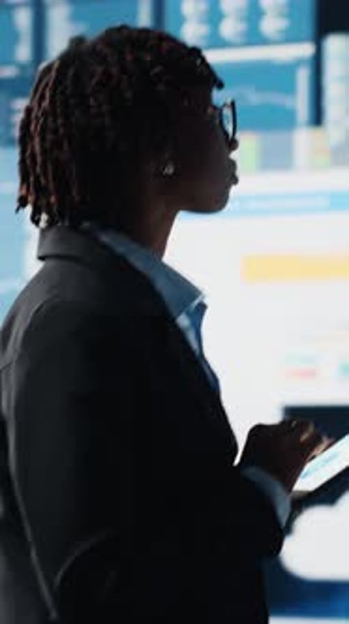 Vertical Video Woman Using Tablet to Compare Company KPIs Data