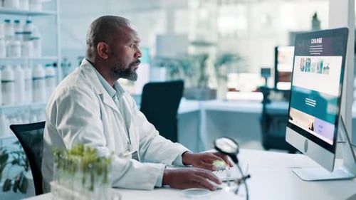 Science, healthcare and black man on computer in laboratory for research, website and internet