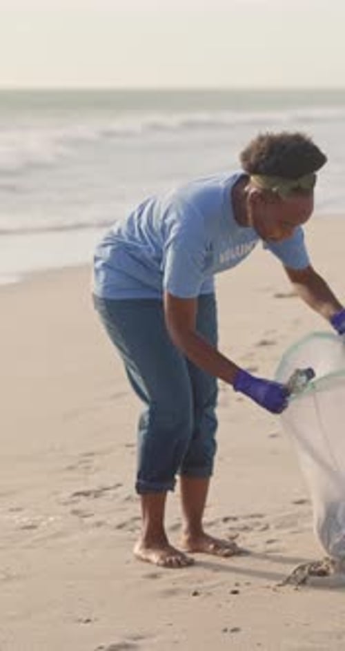 Volunteer, beach and cleaning garbage for pollution management, global warming or community service
