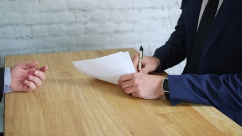 Businessmen Signing Contracts and Sealing the Deal