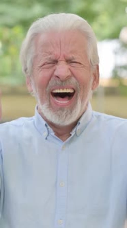 Furious Senior Man Yelling and Raising Arms Outside