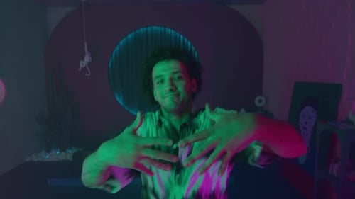 Energetic Dancer Performing Hip Hop Style in Neon Lighted Studio