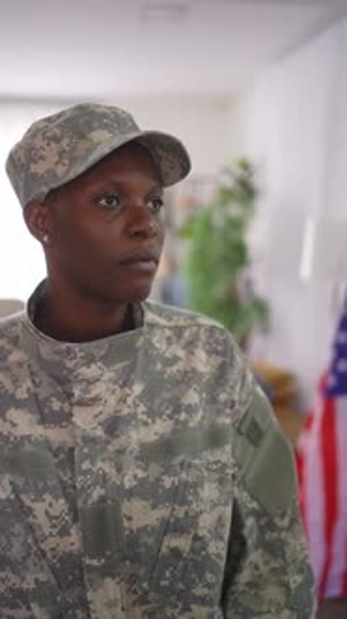 Woman in Military Uniform Standing Indoors