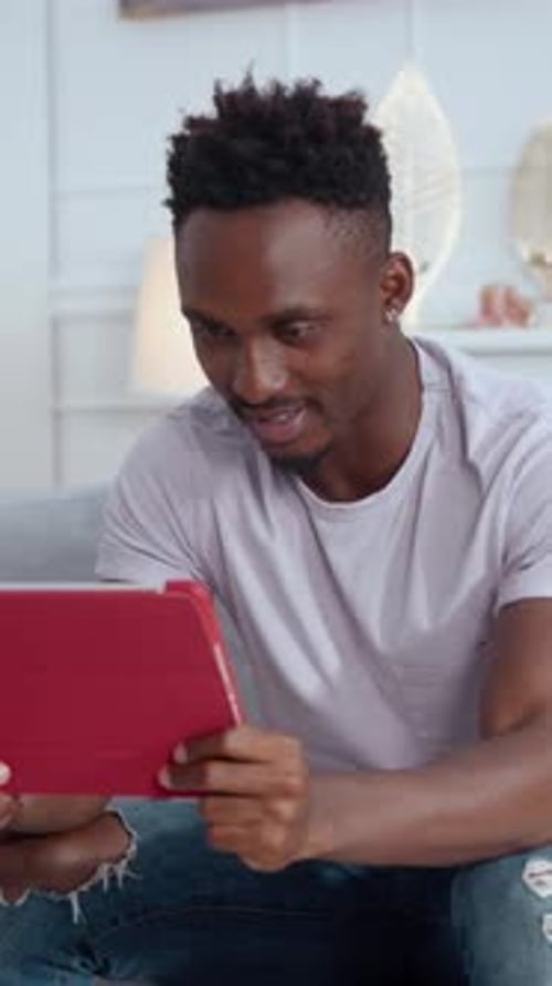 Man Using Tablet Device for Communication Indoors