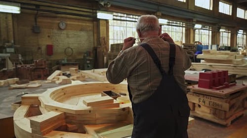 Senior Man Working in Factory Workshop