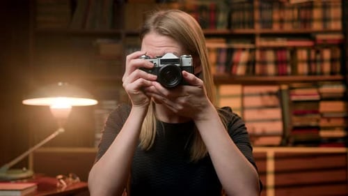 Woman Holds Retro Camera, Looks Through Viewfinder