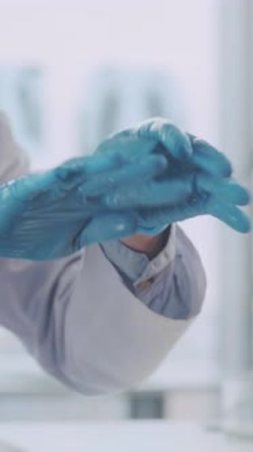 Medical Professional Preparing Injection Wearing Gloves and Mask