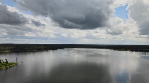 Dark Clouds Reflected Over Tranquil Lake. Aerial Drone Shot