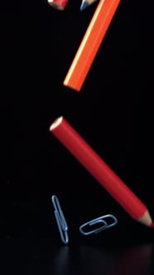 Different School Objects Fly and Fall Against the Background of the Blackboard Filmed on a Highspeed
