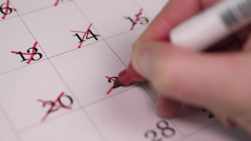 Calendar Closeup Of Hand Rhythmically Crossing Dates On Calendar With Red Pen Detailed View Of Hand