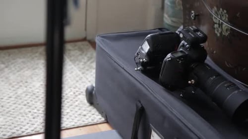 Black Camera and Flash on Rolling Camera Case