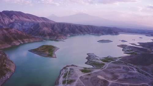 Breathtaking aerial view on a beautiful lake surrounded by mountains lit by a summer sunset sky in A