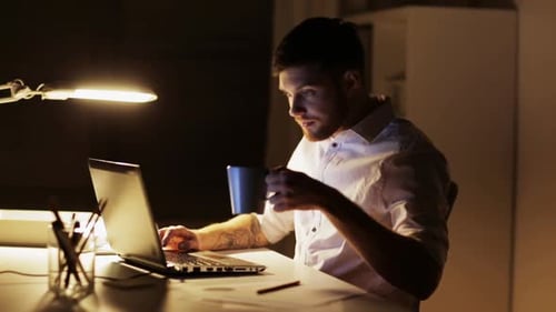 Man Working Late at Night on Laptop