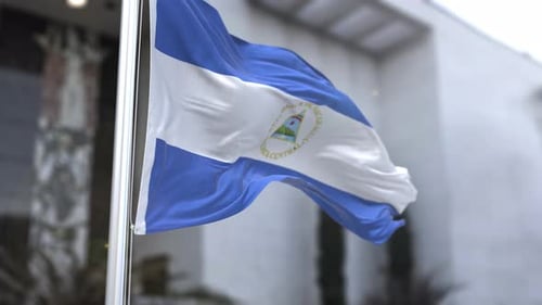 Nicaragua Flag Waving with Building Background
