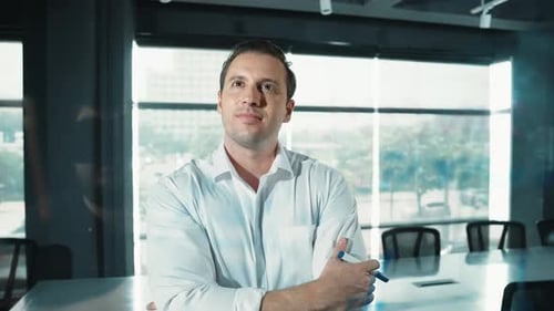 Businessman thinks about start up project in front of glass board. Manipulator.