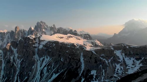 Drone Pan Across Snow-Capped Dolomites at Sunset – Aerial 4K Winter Landscape