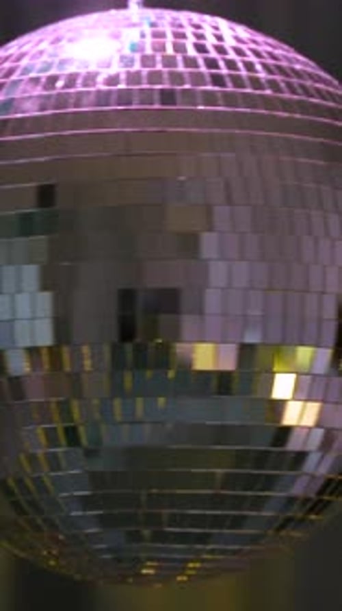 Green disco ball spins. Vertical