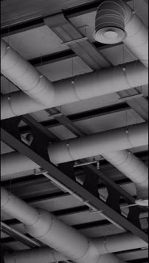 Electrical and ventilation systems, connections with cables and metal pipes inside a modern building