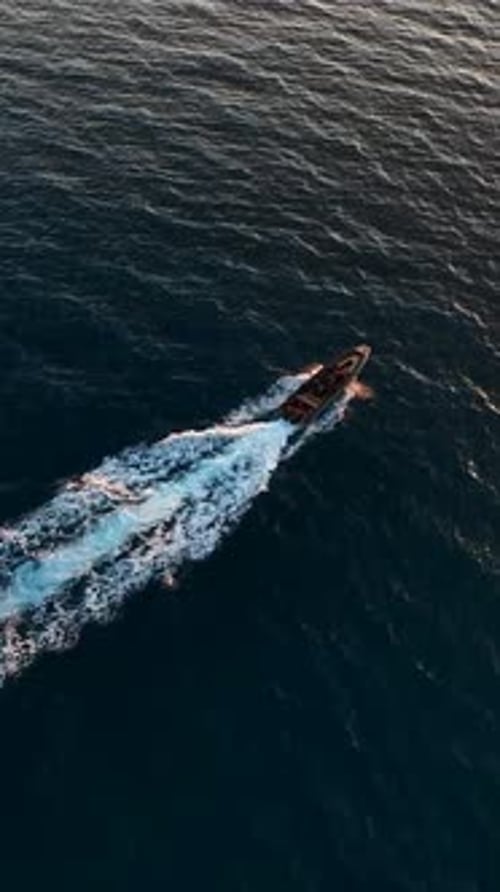 Vertikales Video Coastal Serenity Luftbild eines Luxus-Sportboots im Sonnenuntergang