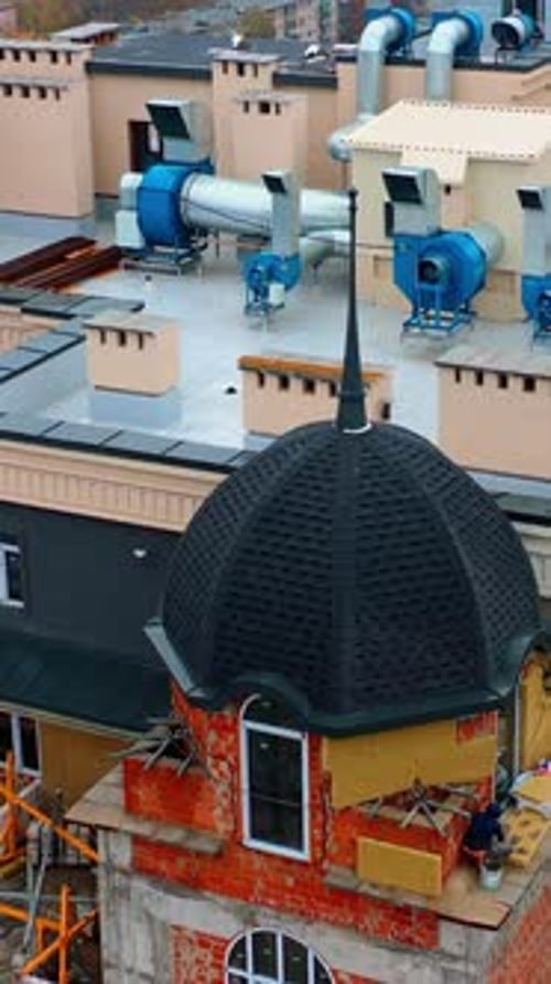 Construction of modern tower house. Workers build the on the top of multi-storey building.