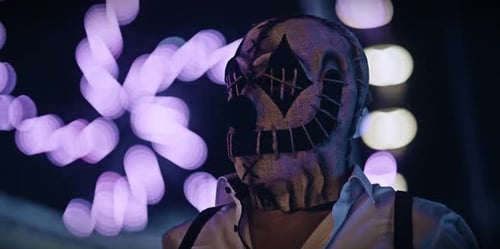 Mysterious Masked Figure Standing in Urban Night Setting