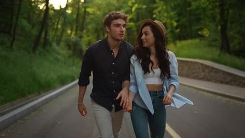 Romantic Couple Walking in Park at Sunset. Closeup Man Taking Woman Hand