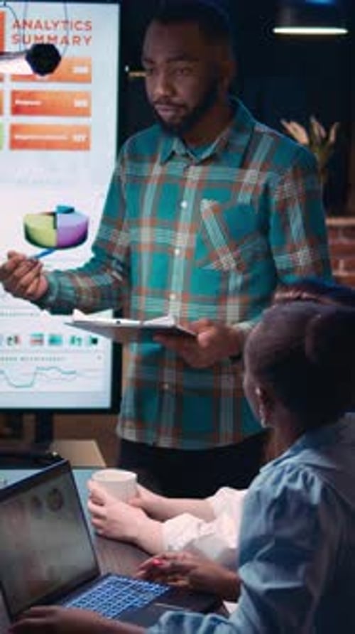 Team Discussing Analytics in Modern Urban Office