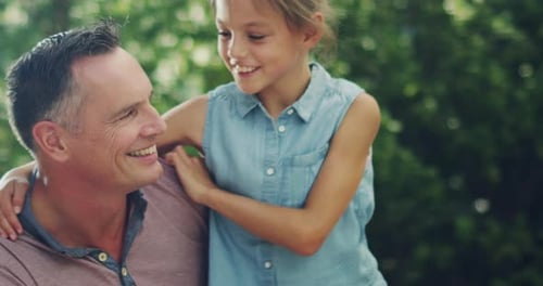 Father and Daughter Embrace with Affectionate Smiles