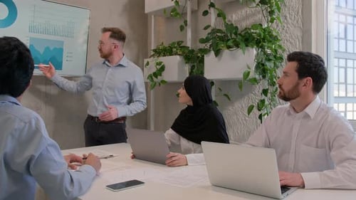 Office Team Leader Man Mentor Show Charts Financial Growth Graphics Presentation on Interactive