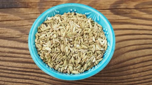 Dried fennel seeds piled in a bowl