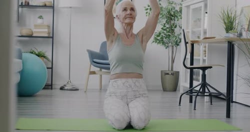 Senior Woman Practicing Yoga at Home