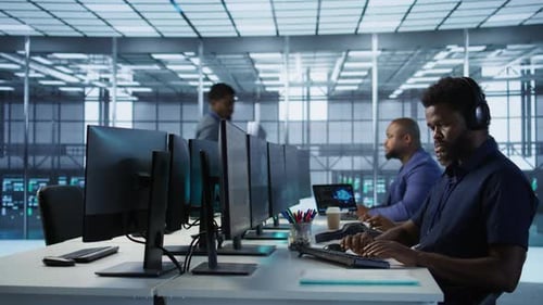 Data Center Admin Typing on Keyboard Maintaining Company Infrastructure