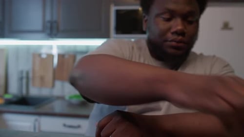 Adult Man Prepares Healthy Snack in Kitchen