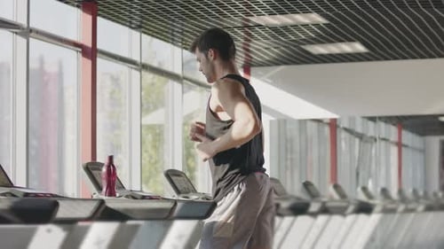 Runner Man Training on Treadmill Machine at Workout in Fitness Center. Fitness